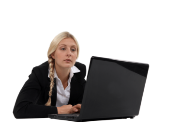 a woman sitting at her desk using a laptop