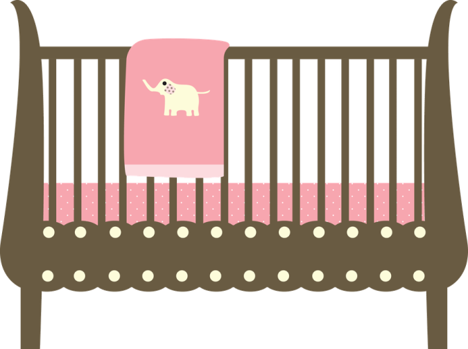 a baby cribt with a pink blanket on it