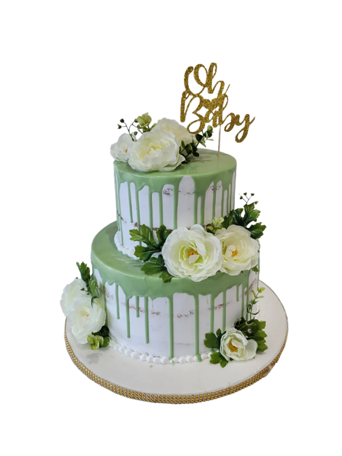 a green and white cake with flowers on top