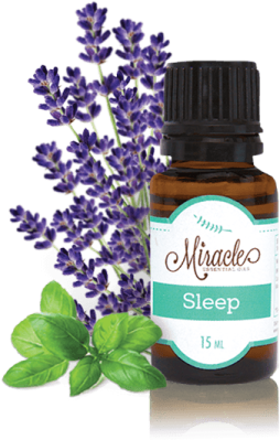 a bottle of lavender essential oil next to some flowers