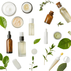 a variety of skin care products with green leaves