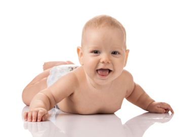 a baby laying on the floor in diapers