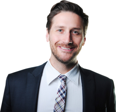 a man in a suit and tie smiles at the camera