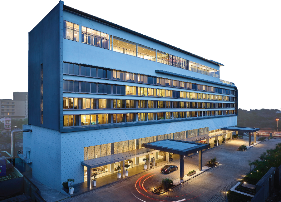 a large white building with many windows at night