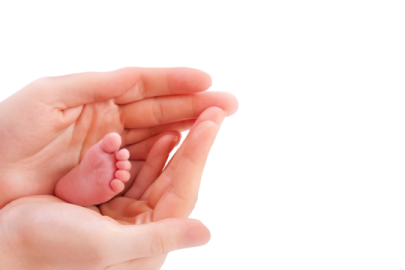 a hand holding a baby's foot