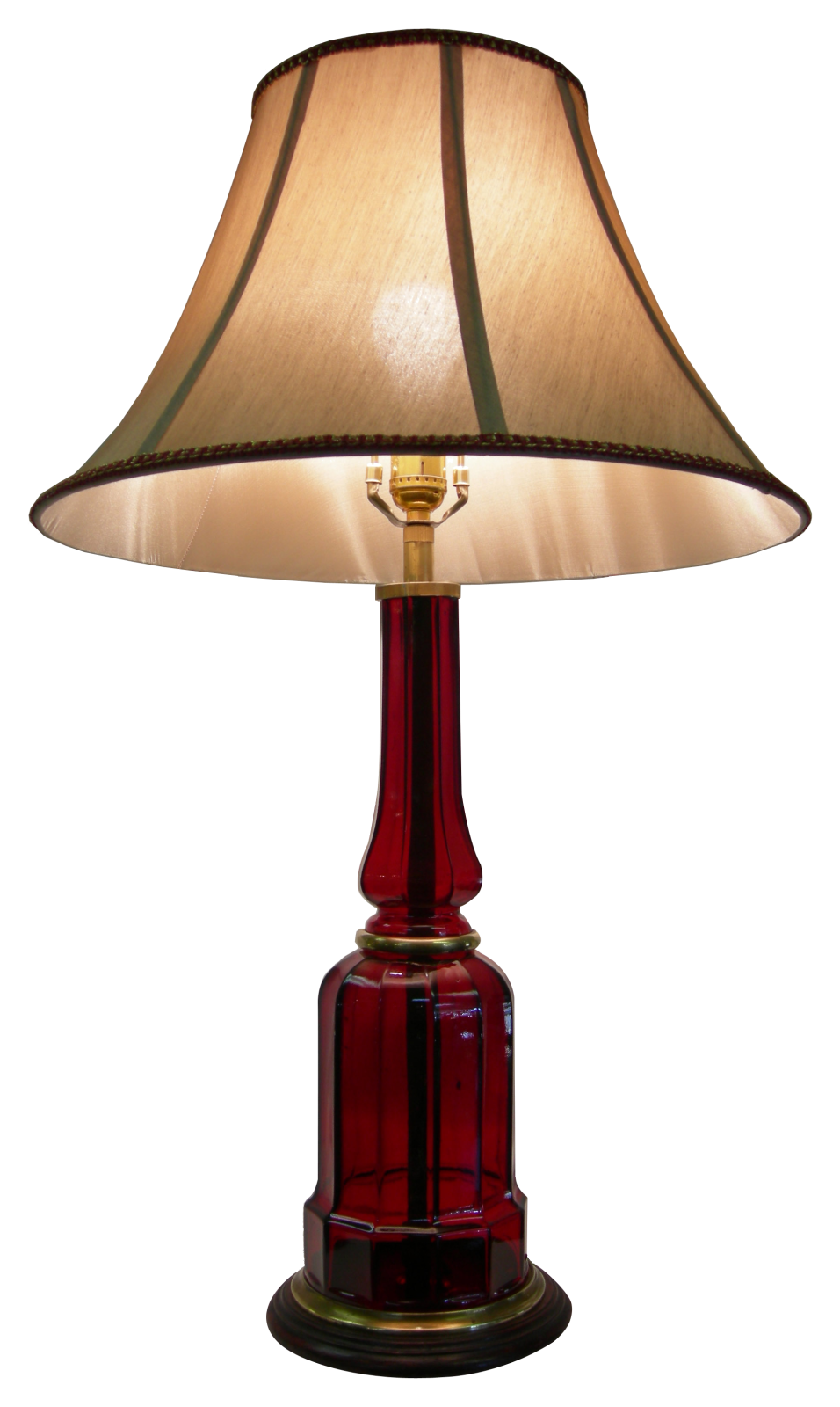 a red table lamp with a beige shade