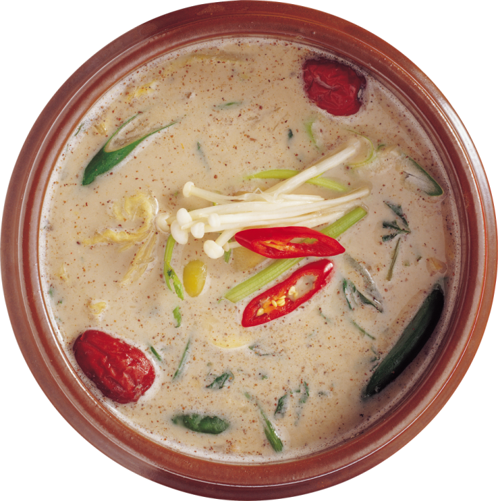 a brown bowl filled with soup and vegetables