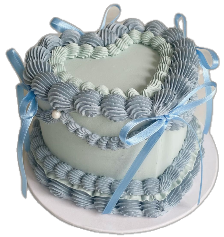 a heart shaped cake with blue ribbons on top