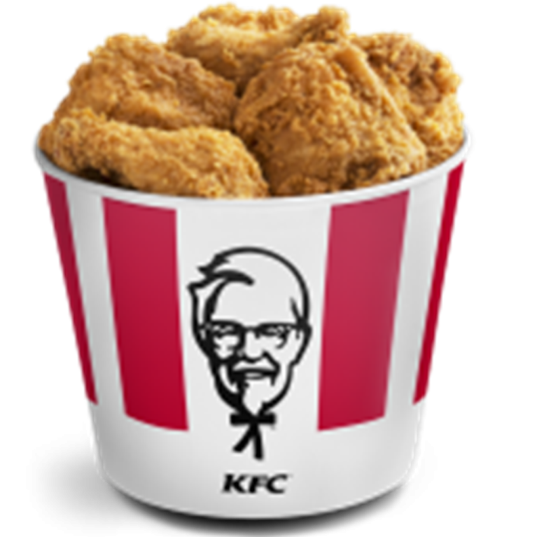 a cup filled with fried chicken sitting on top of a table