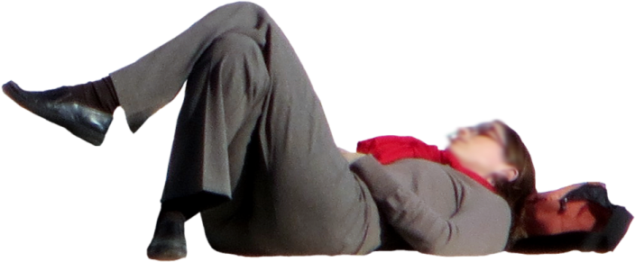 a man in a suit laying on the ground