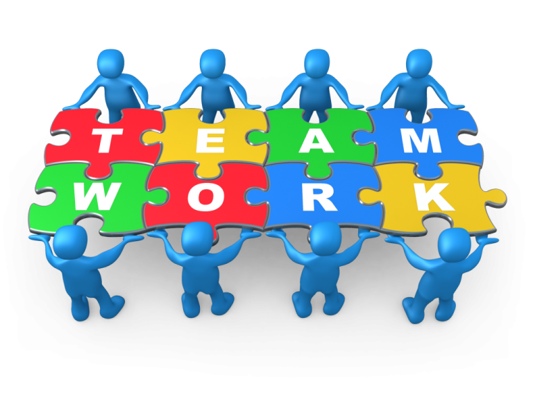 a group of people holding puzzles with the words teamwork