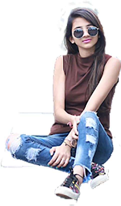 a woman sitting on the ground wearing sunglasses