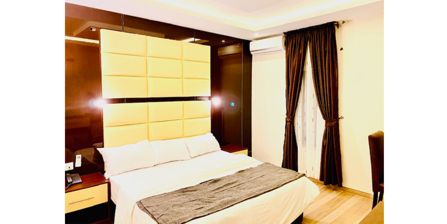 a hotel room with a bed and curtains