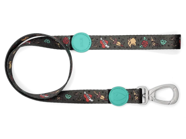 a black dog leash with a green button on it