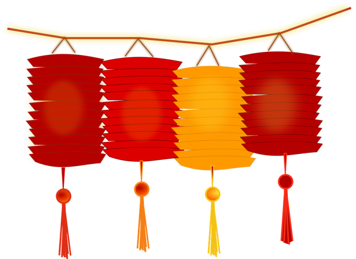 three red and yellow lanterns hanging from a tree branch