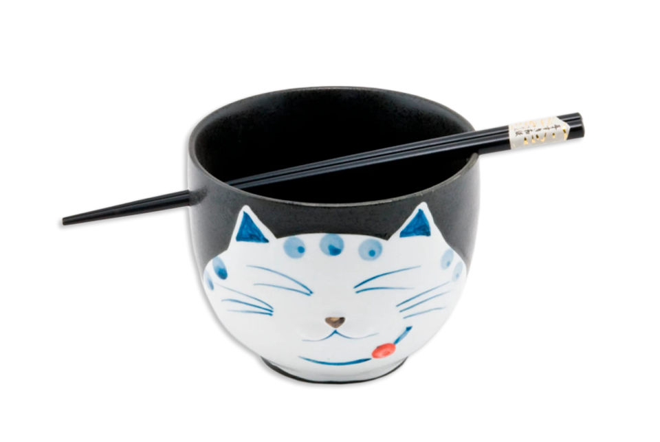 a black and white cup with a cat face on it