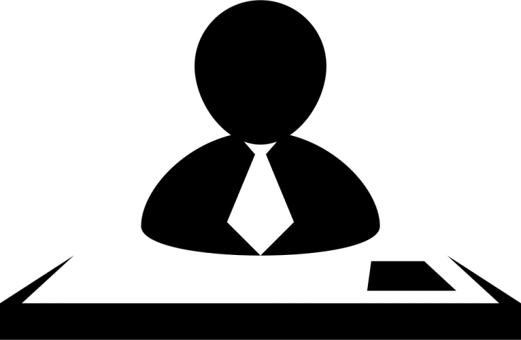 a black and white silhouette of a person sitting at a desk