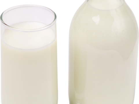 a bottle of milk next to a glass