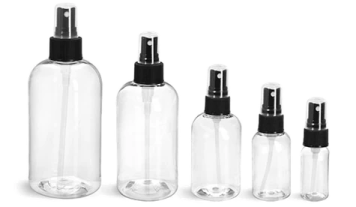 a set of four clear bottles with black caps