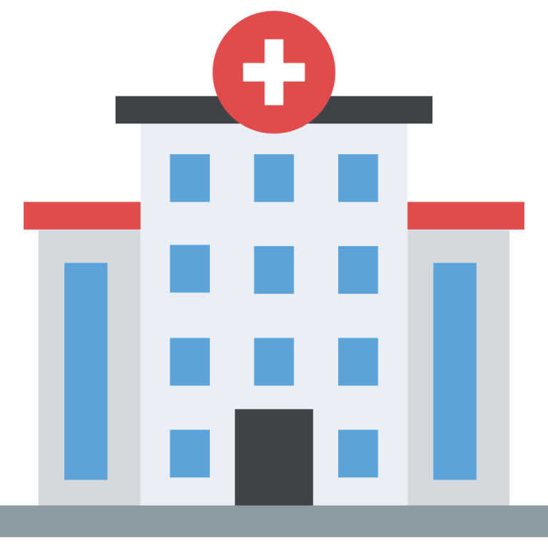 a hospital building with a red cross on top