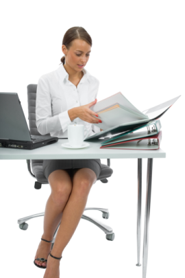 a woman sitting at a desk with a laptop and papers