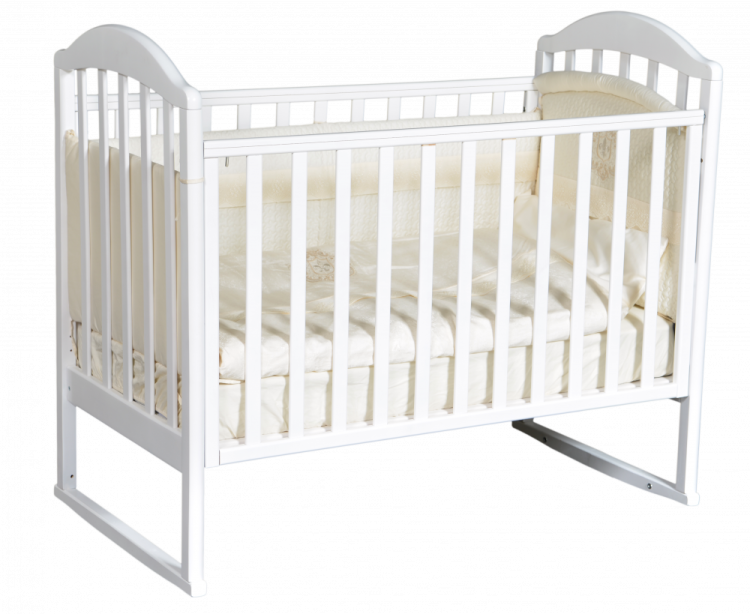 a baby cribt with white sheets and pillows