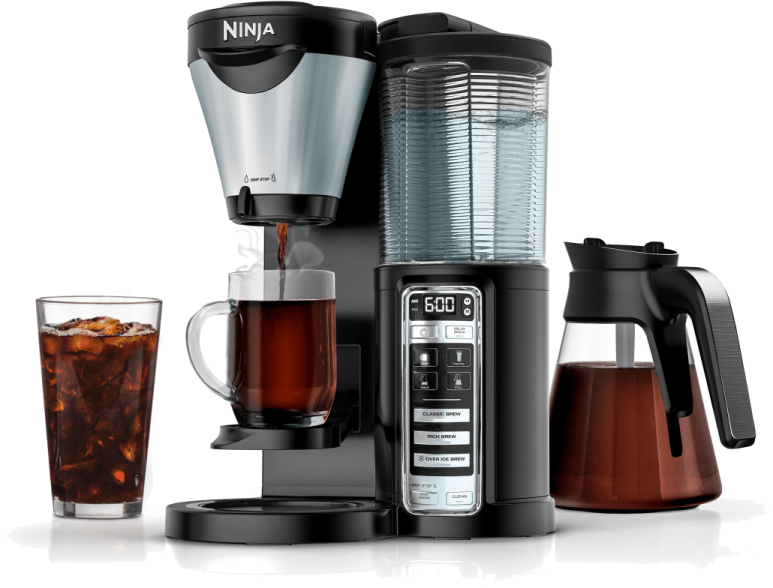 a black and silver coffee maker next to a glass