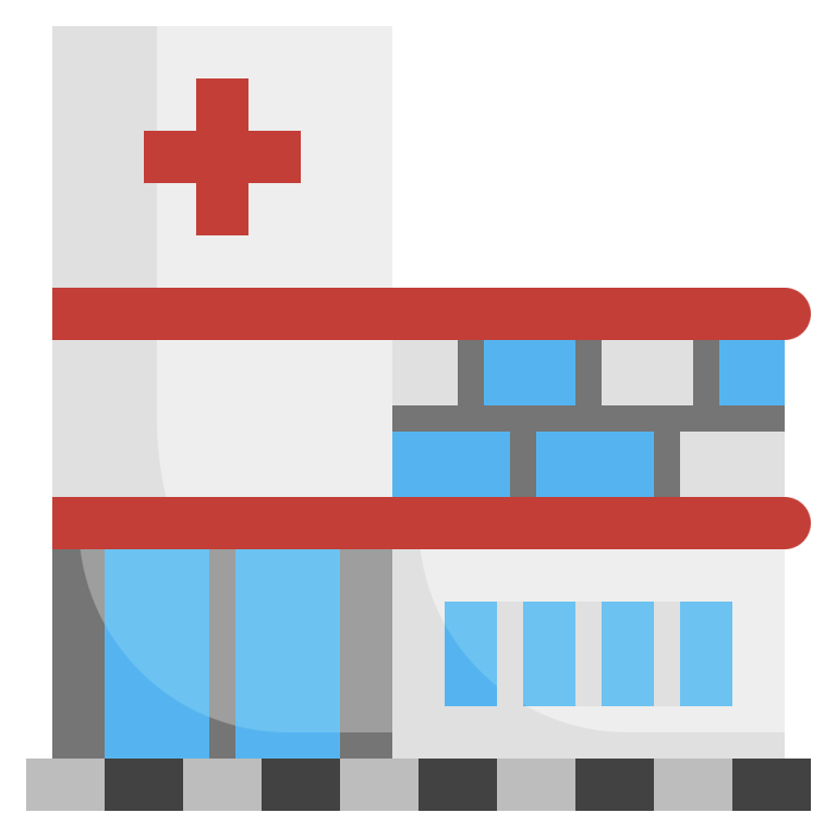 a hospital building with a red cross on top