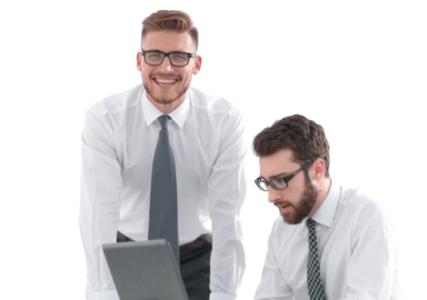 two men in white shirts and ties looking at a laptop