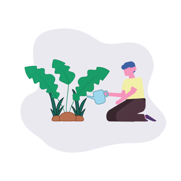 a person sitting on the ground with plants in their hands