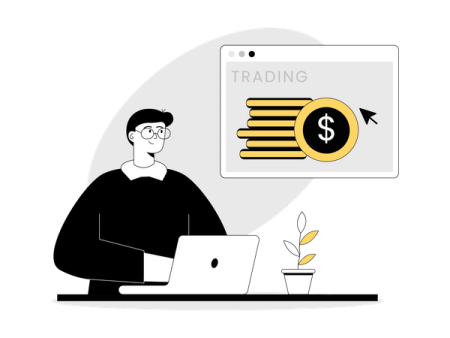 a man sitting in front of a laptop with the word trading on it