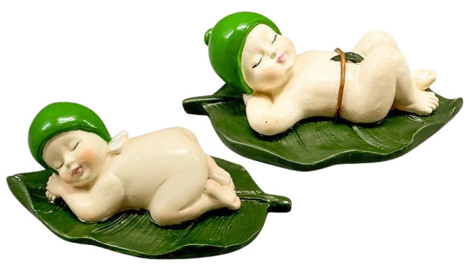two small figs of a baby sleeping on a leaf