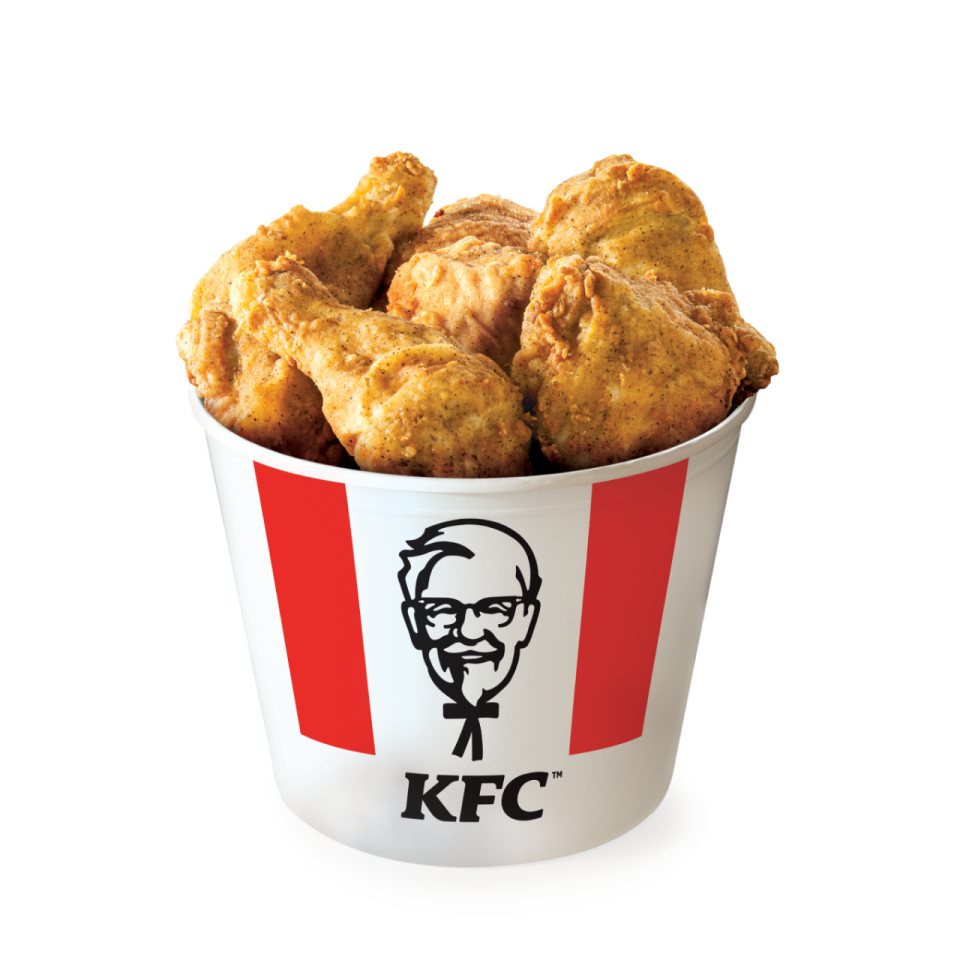 a cup filled with fried chicken sitting on top of a table