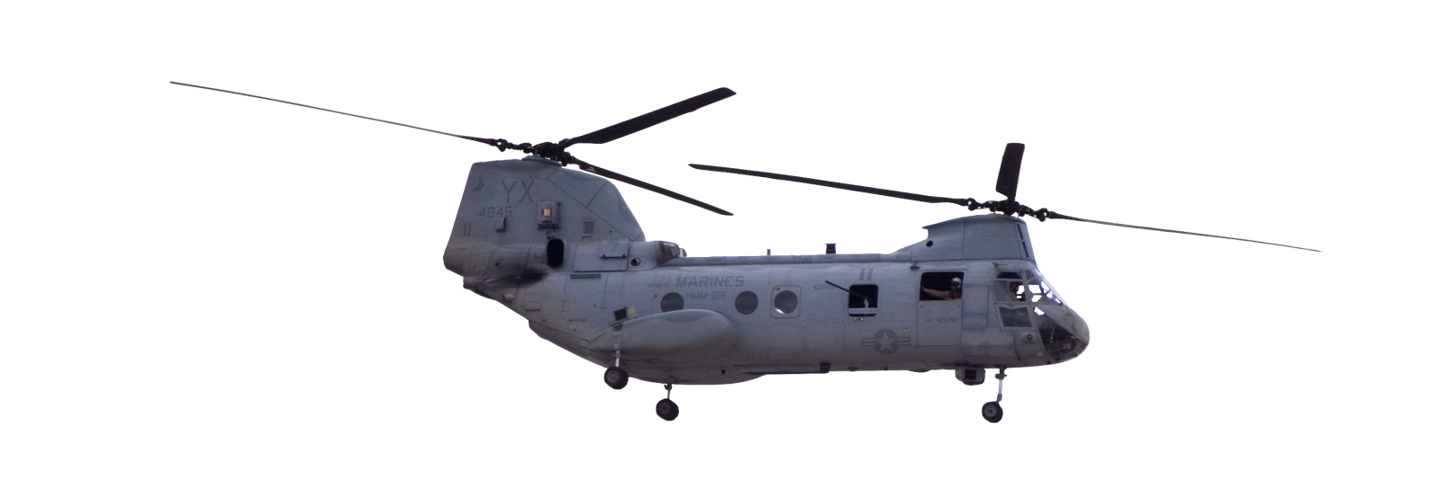 a military helicopter flying in the sky