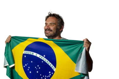 a man holding up a brazil flag