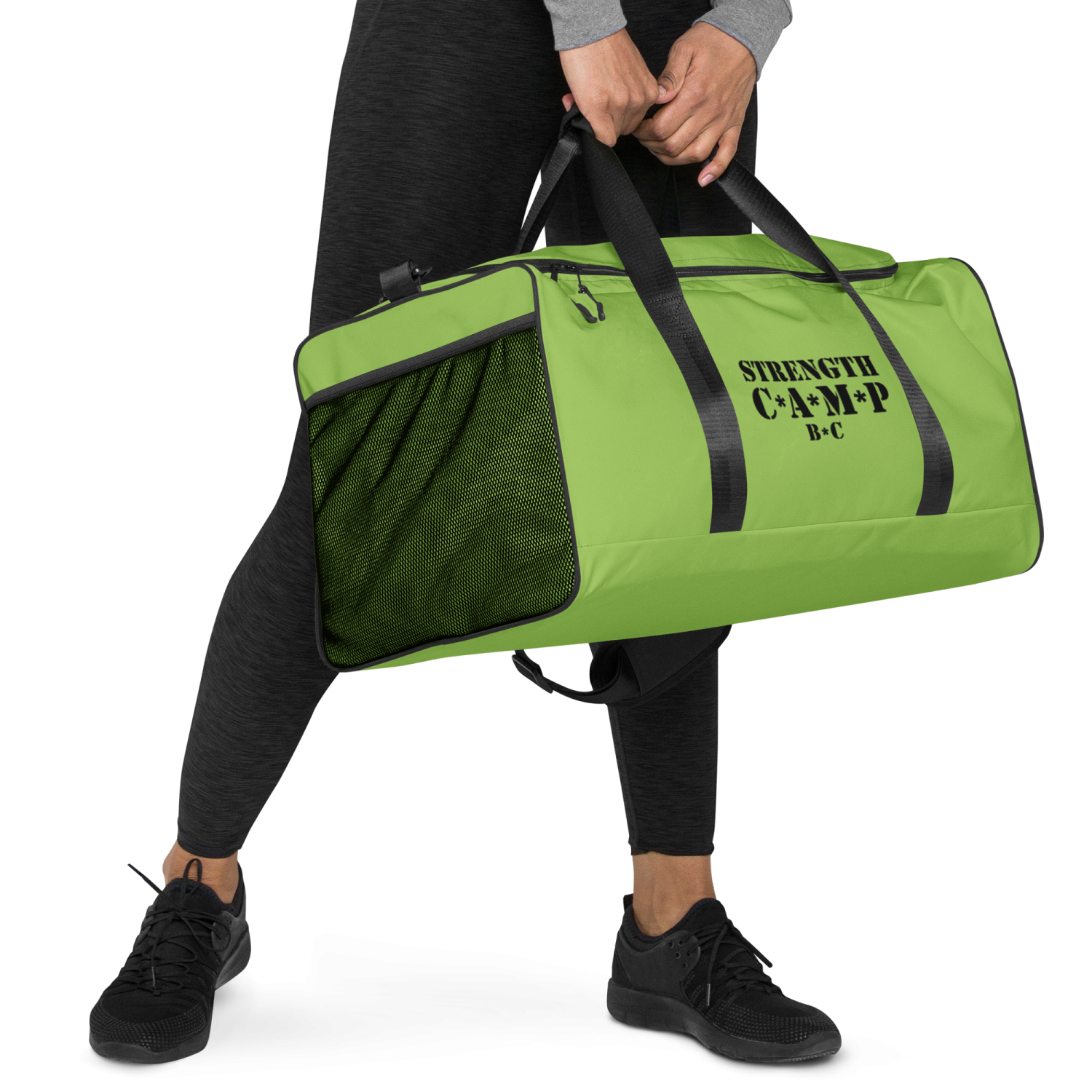 a man carrying a green gym bag