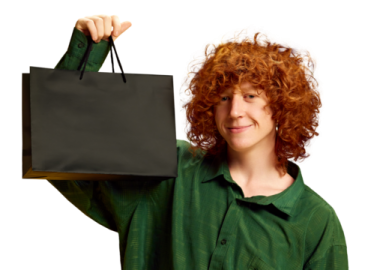 a woman holding up a black shopping bag