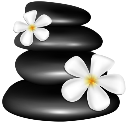 a stack of black stones with white flowers on top