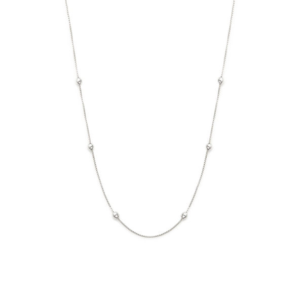 a white gold necklace with three diamonds