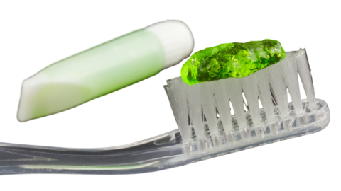 a close up of a tooth with a green toothbrush
