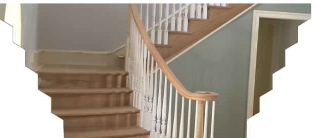 a staircase with white railing and wood handrail