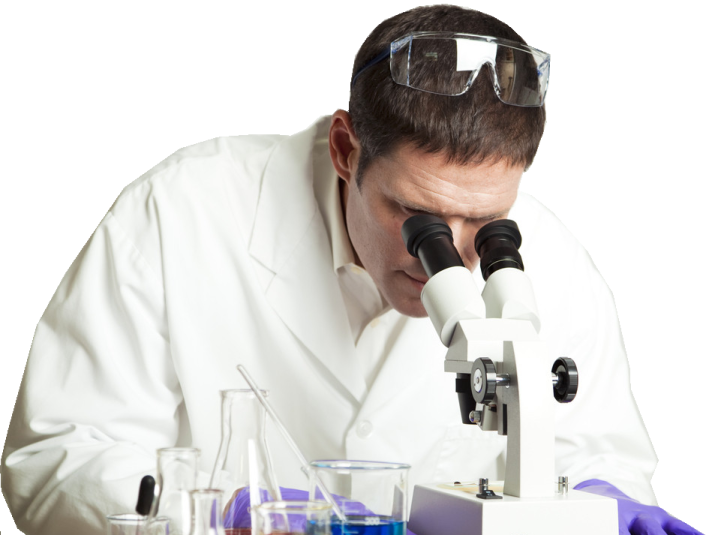 a man in a lab coat looking through a microscope