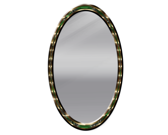 an oval mirror with a green and gold frame