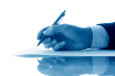 a person writing on a piece of paper