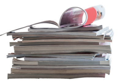 a stack of newspapers with a magni on top