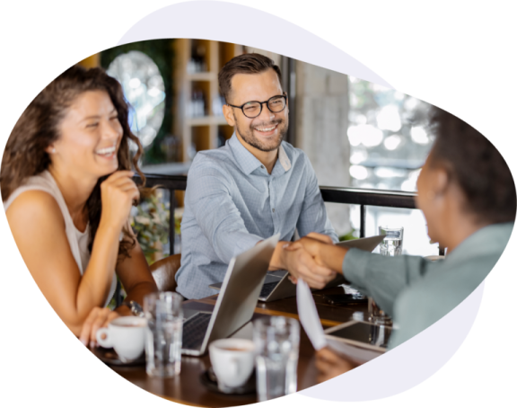 a man and woman sitting at a table talking to each other people
