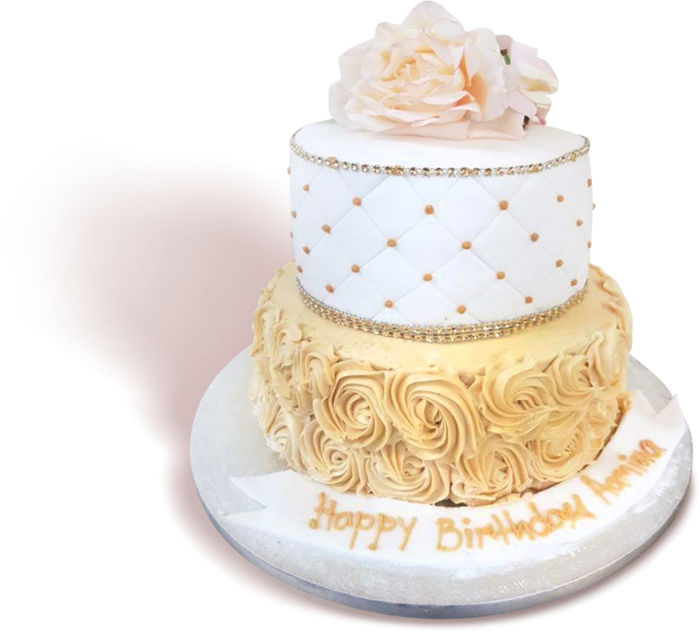 a white cake with gold decorations and flowers on top