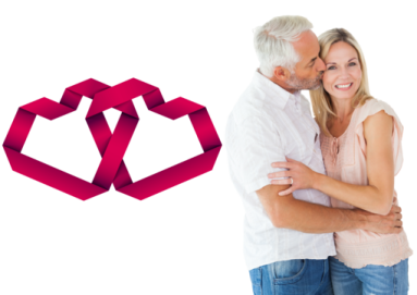 a man and woman hugging in front of a red ribbon