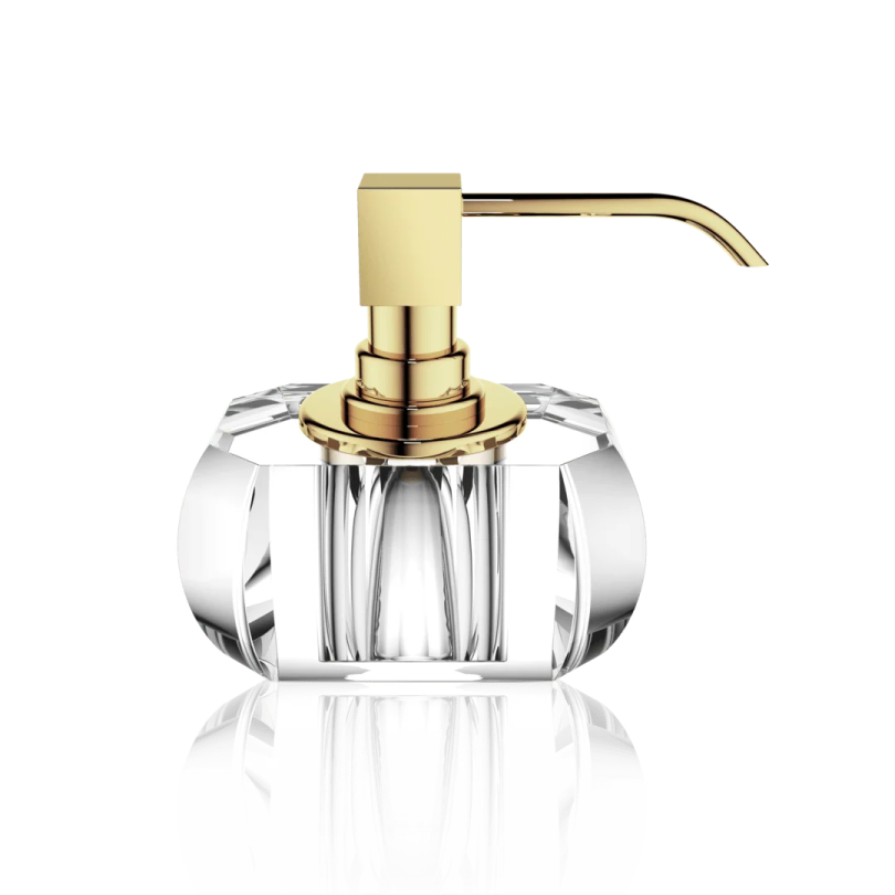 a gold and clear glass soap dispenser on a white background