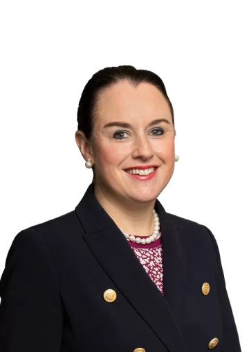 a woman in a black jacket and pink shirt